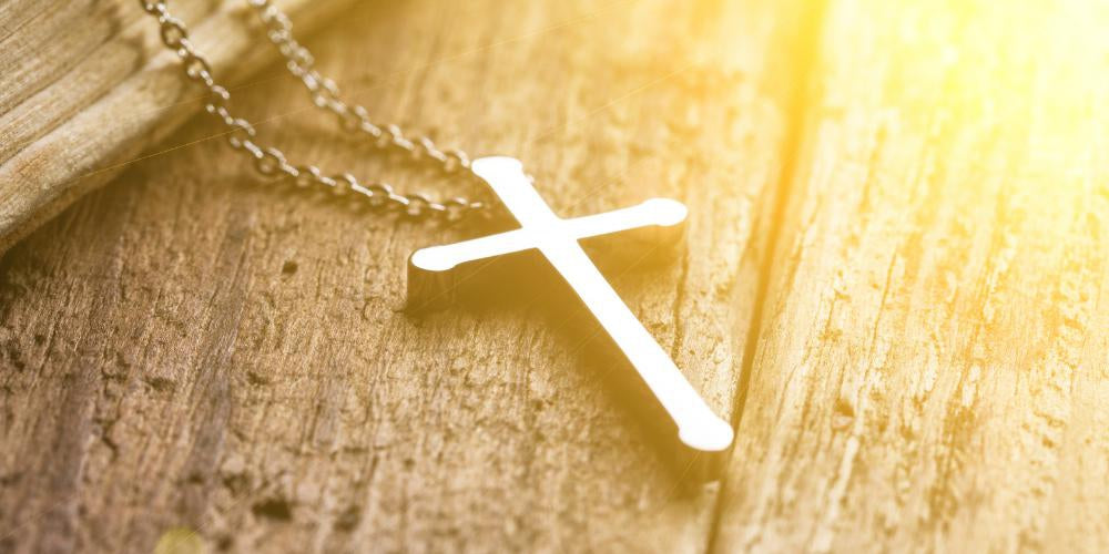 Silver cross necklace on display, available in Australia